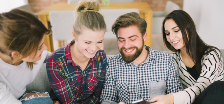 group of people looking at a mobile phone