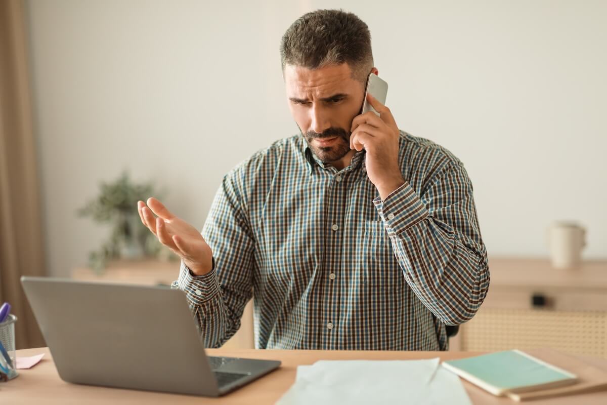 Behavioral health referral: stressed manager talking on the phone