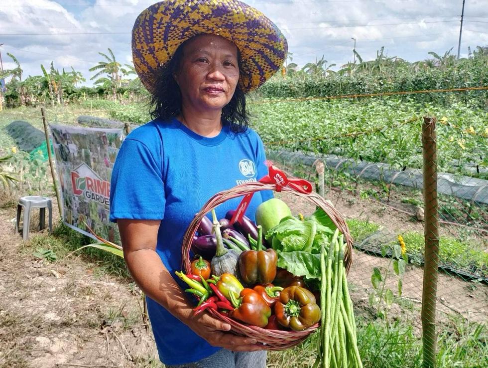 A person holding a basket of vegetables

Description automatically generated