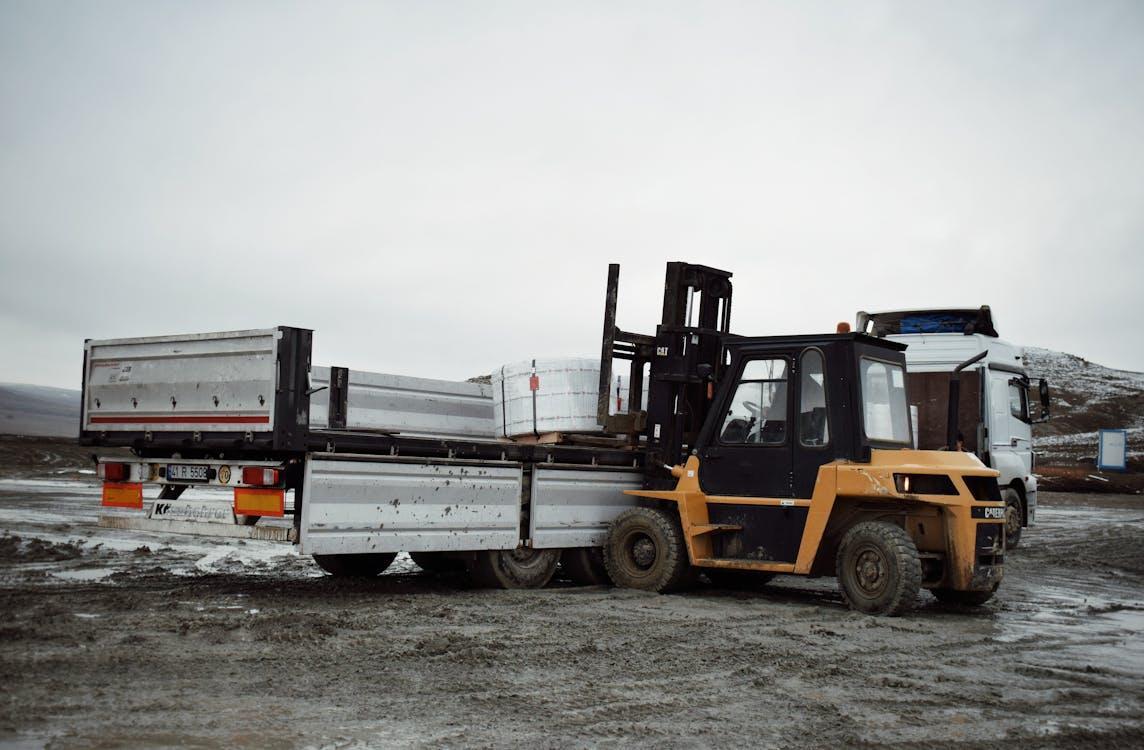 Free Forklift Loading Cargo on Truck Stock Photo