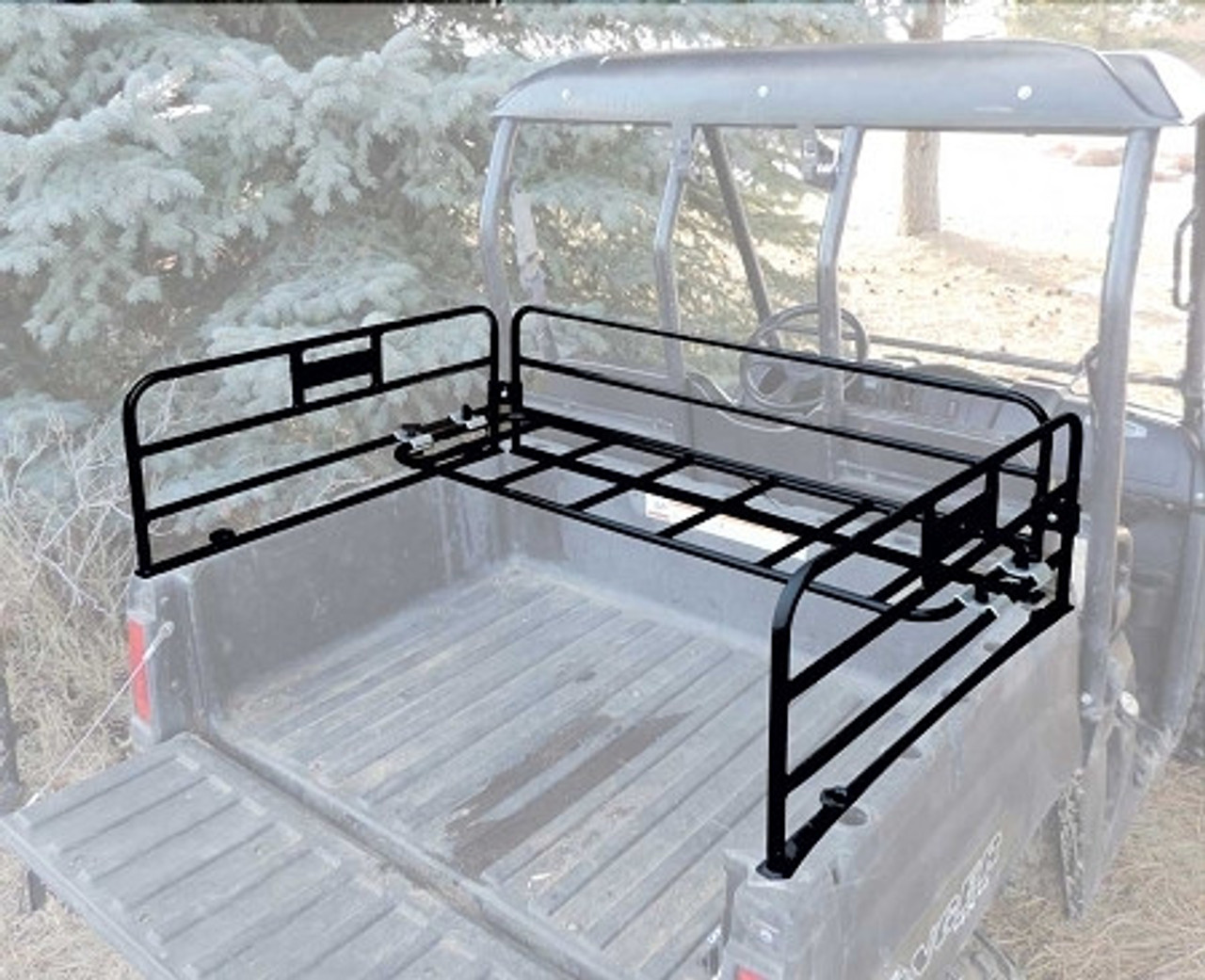 A Polaris Ranger parked on grass next to a tree, outfitted with bed rails from Hornet Outdoors. 