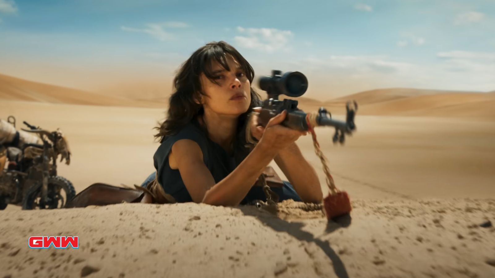 Woman aiming a rifle in a desert landscape.