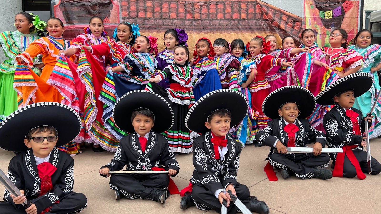 Children and women dressed in traditional clothing.