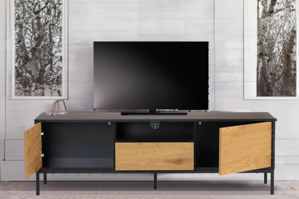 Light brown solid wood TV cabinet with doors, drawer, and cable management hole
