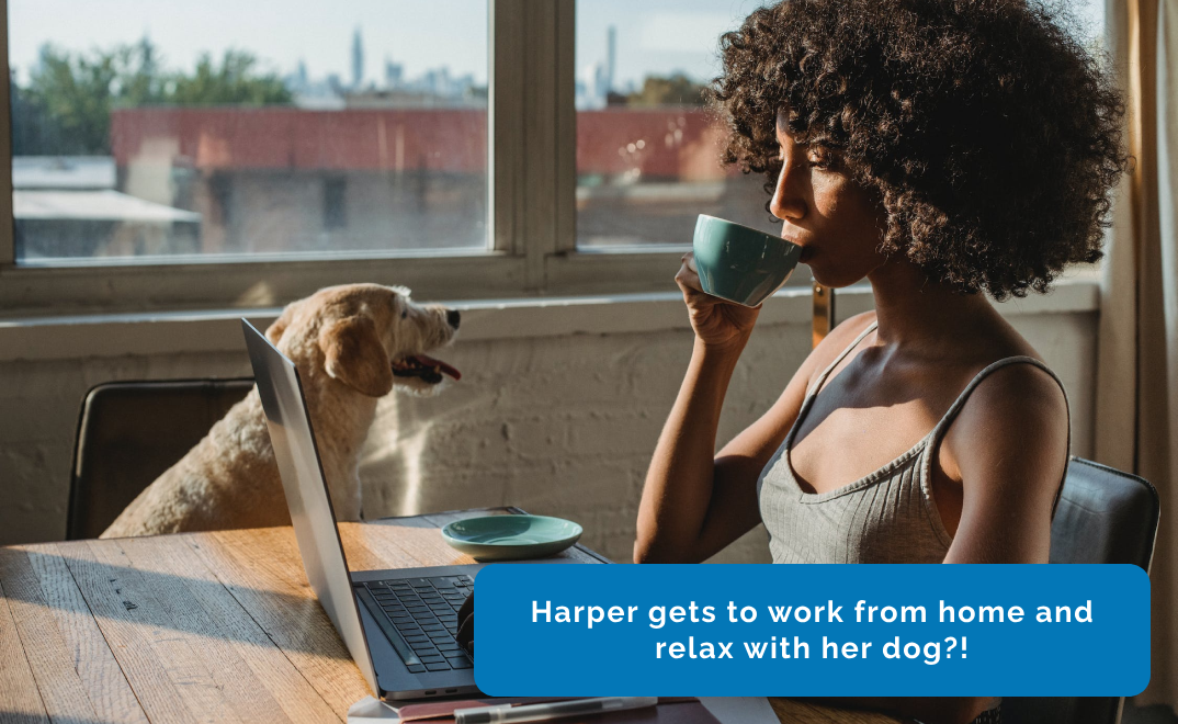A woman working from home while her dog is sitting next to her.