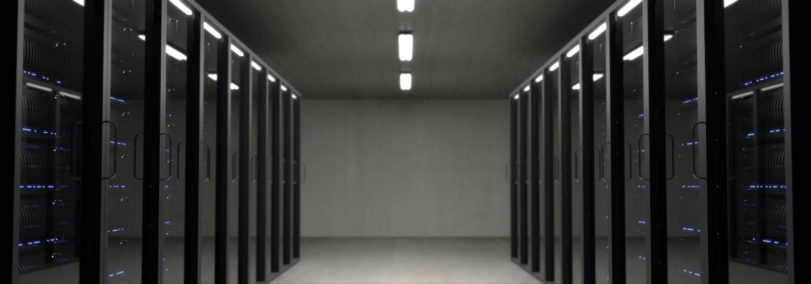 A view of a server room with server racks along both sides.