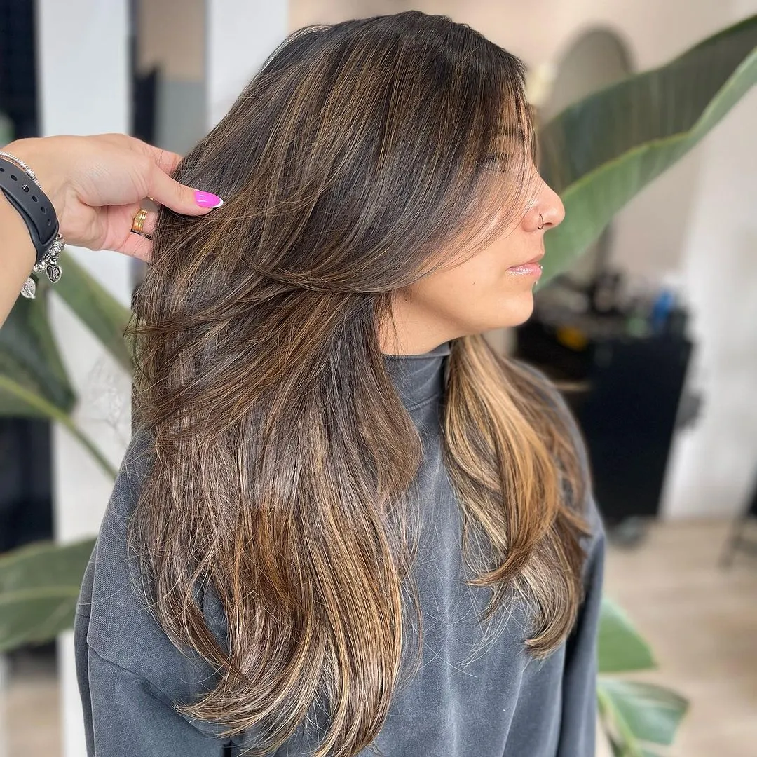 Side view of a lady rocking her mane with layers