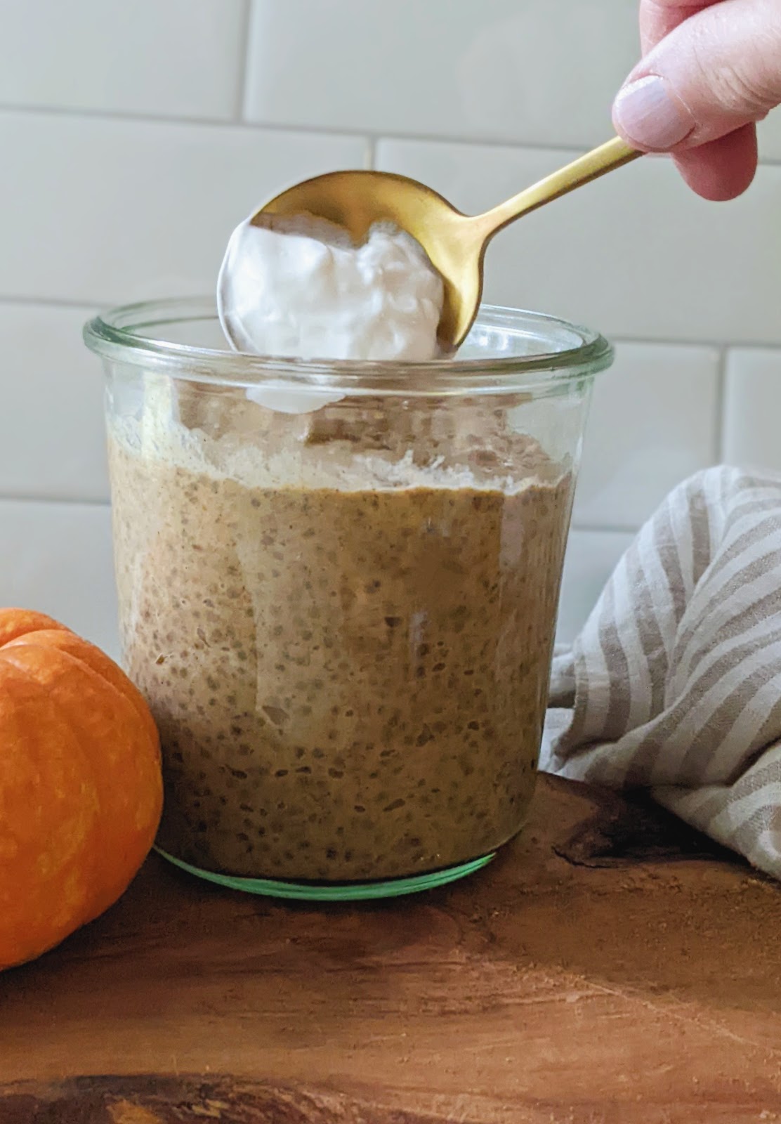 close up of chia pudding with vanilla yogurt being added to it