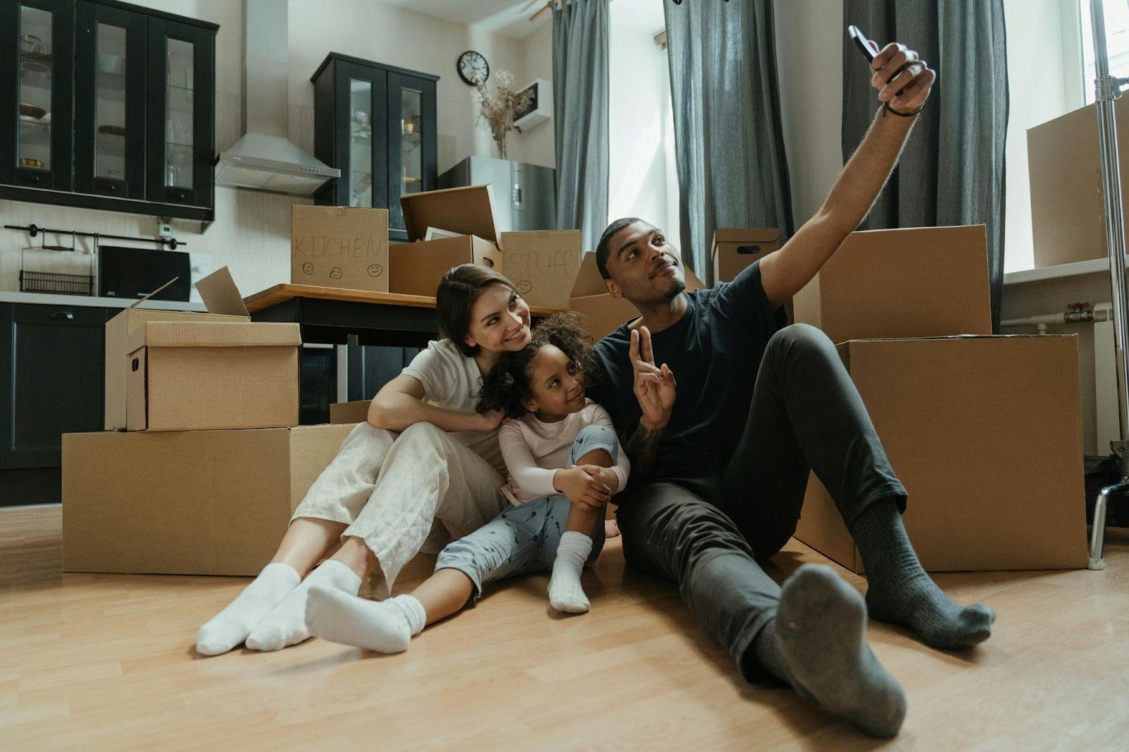 couple with child moving into their new home with boxes around them