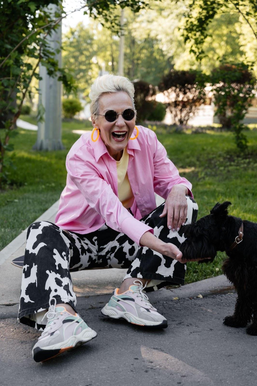 Woman feeding supplements to a senior dog