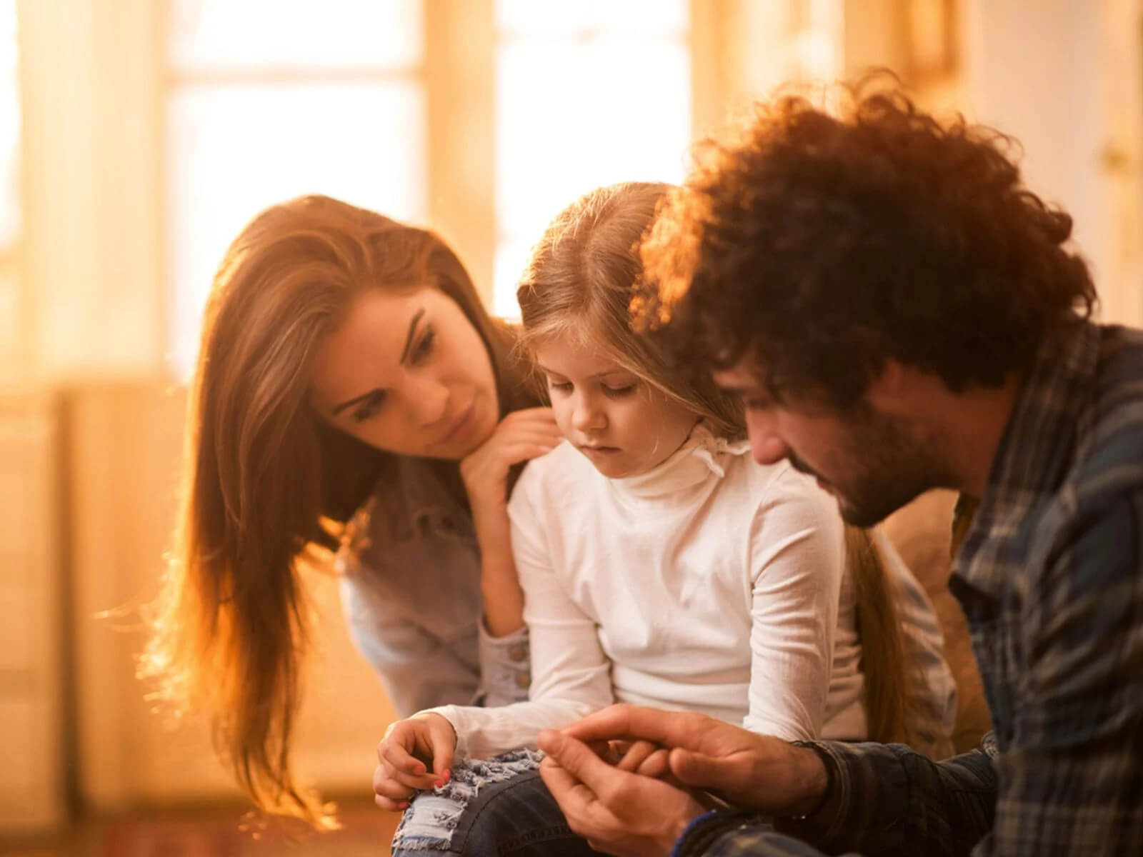 sad baby with parents