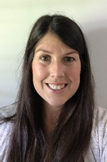 A person with long hair smiling

Description automatically generated