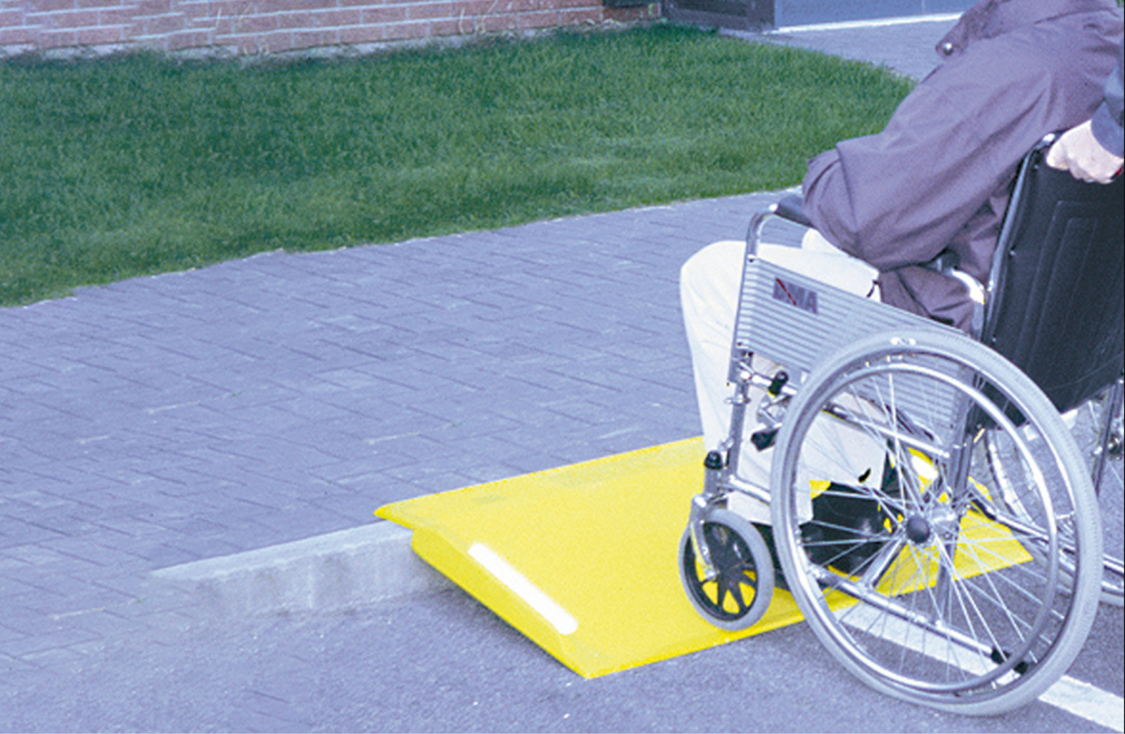 A wheelchair or portable kerb ramp