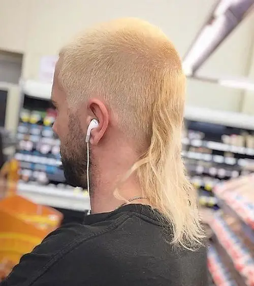 Back view  of a man  rocking the beach blonde skullet hairstyle