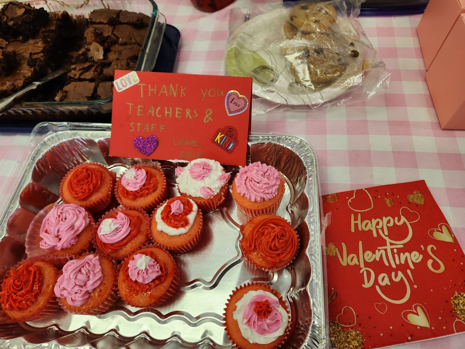 close up image of red, white and pink cupcakes and valentines day cards
