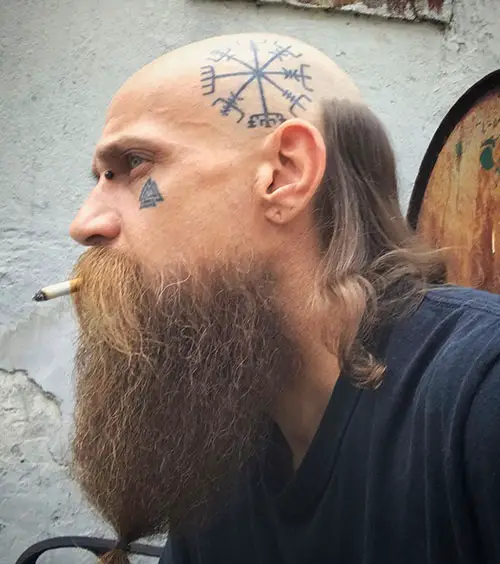 Side view of  a man wearing the viking variation of the haircut 