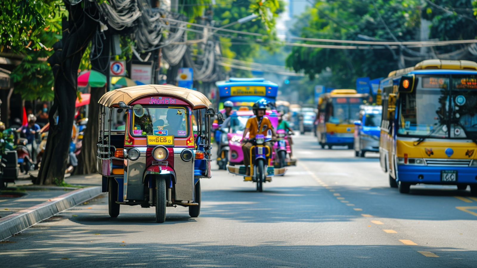 Tuktuks, taxis, and buses on the road in Bangkok