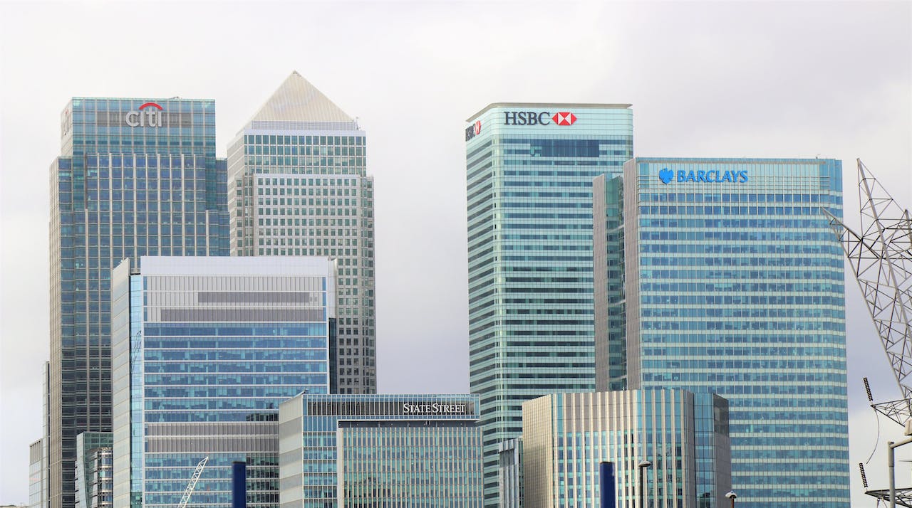 A scene of glass skyscrapers representing all major banks, like Barclays and HSBC