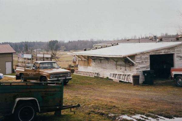 Photo of the crew on a farm salvage in the winter with the truck 'Goldie' in frame. 