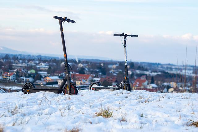 two electric scooter of winter background