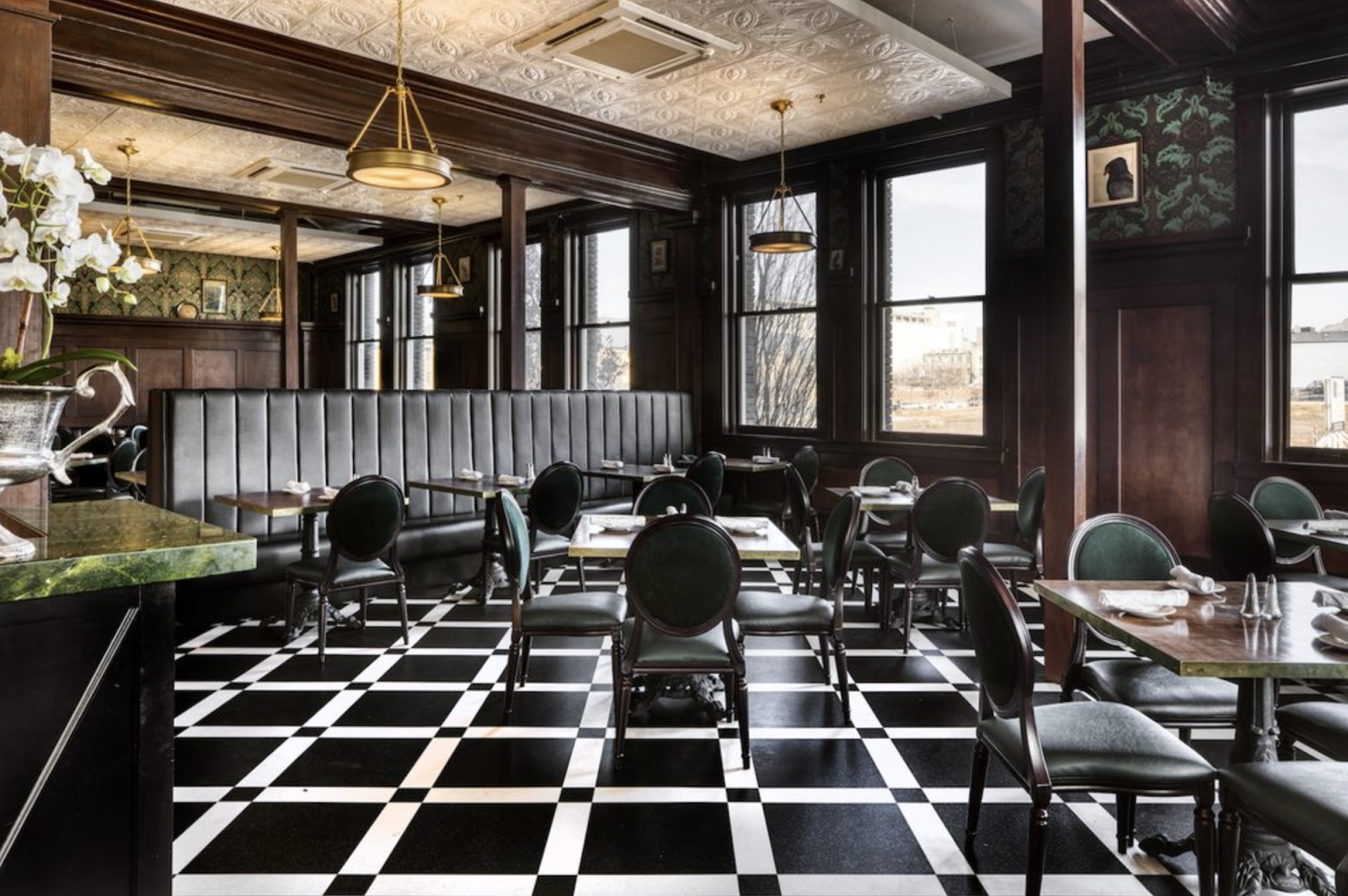 Interior art-filled dining room with black and white checkered flooring at Caffe Molise in Salt Lake City.