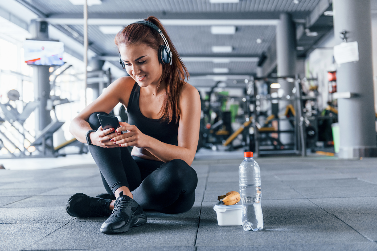 woman reading a text message in a gym