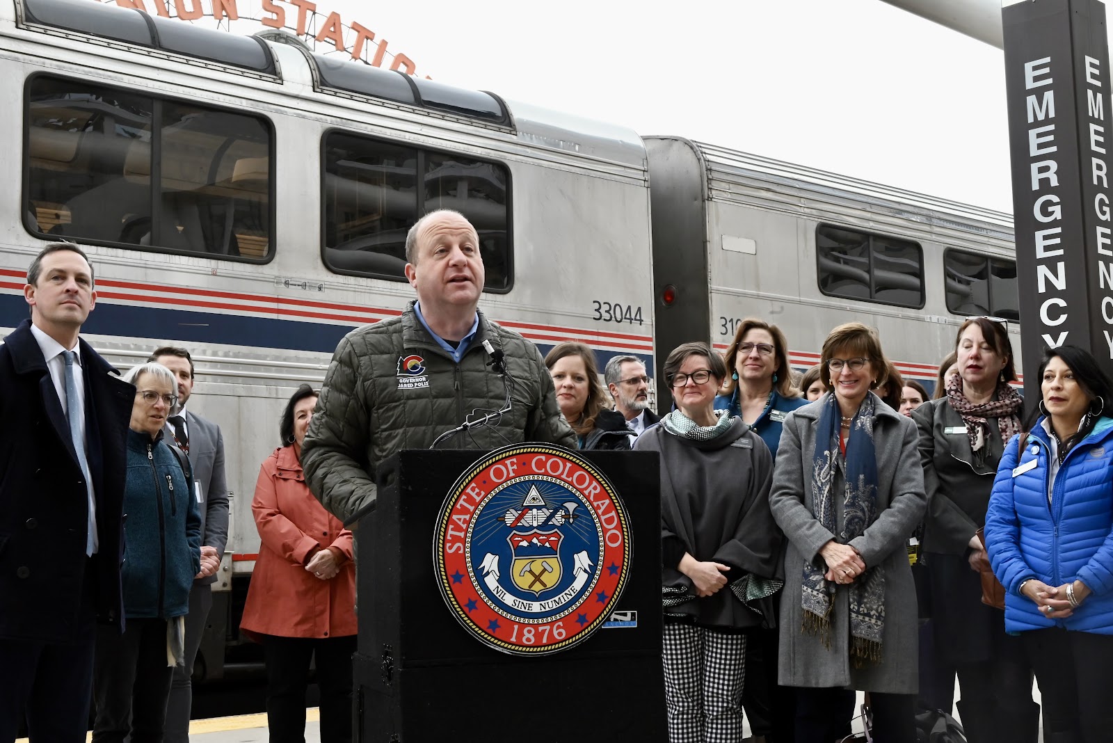 Governor Polis speaks at Union Station in Denver to a crowd in front of a train before leaving for Longmont.